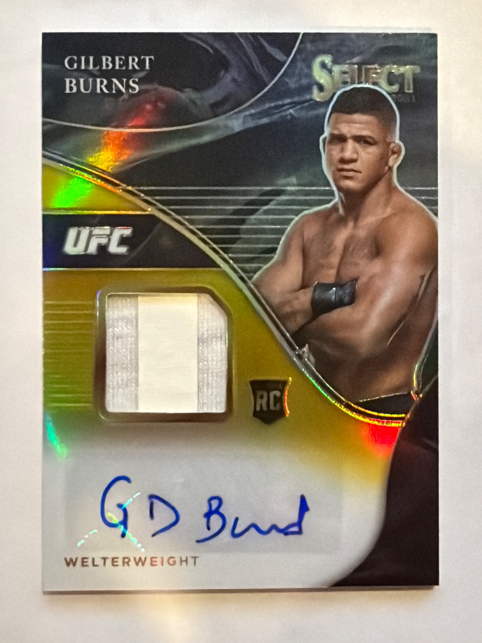 Gilbert Burns RC 2021 Panini Select UFC AUTOGRAPHED MEMORABILIA Gold Prizm /10 #AM-GBN — 2021 · 2021 Panini Select UFC · Gilbert Burns · AUTOGRAPHED MEMORABILIA Gold Prizm · autograph · raw